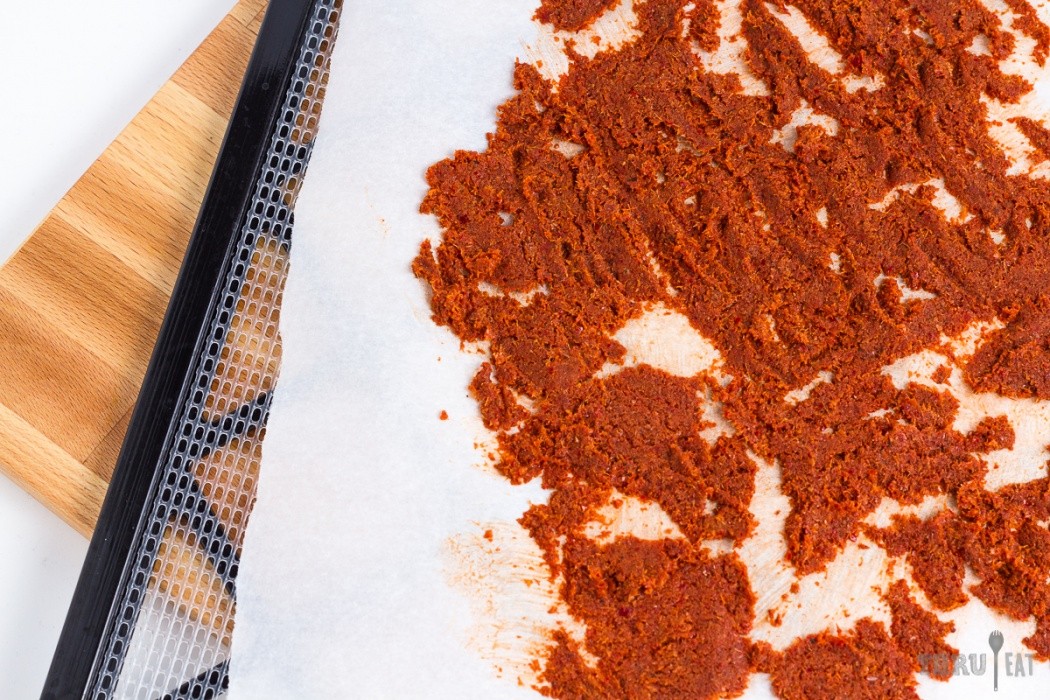 Spread curry paste as thin as possible, smear it if you have to red curry paste spread on a dehydrator tray