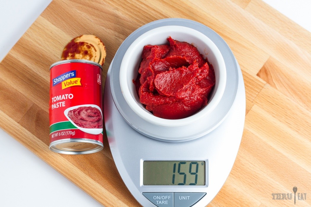 159 grams of tomato paste on a scale