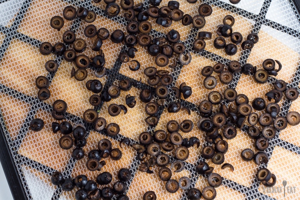 Sliced black olives on a dehydrator tray