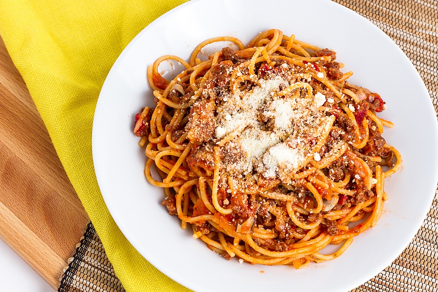 a bowl of spaghetti with parmesan cheese sprinkled on top