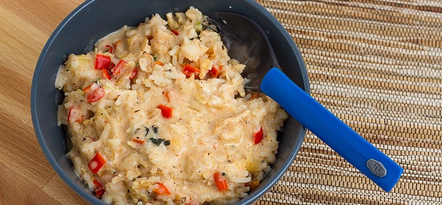 bowl of Thai chicken curry with a blue spork