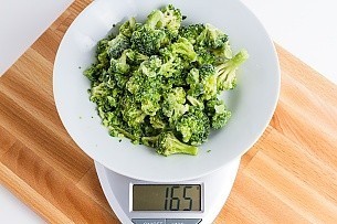 Frozen broccoli makes for really easy dehydrating 165 grams of frozen broccoli on a scale