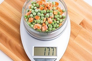 177 grams of frozen peas and carrots on a scale