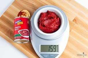 159 grams of tomato paste on a scale