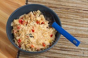 bowl of Thai chicken curry with a blue spork