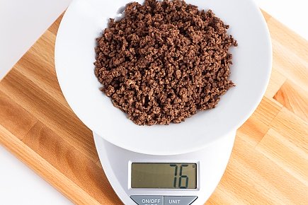 76 grams of dehydrated ground beef on a scale