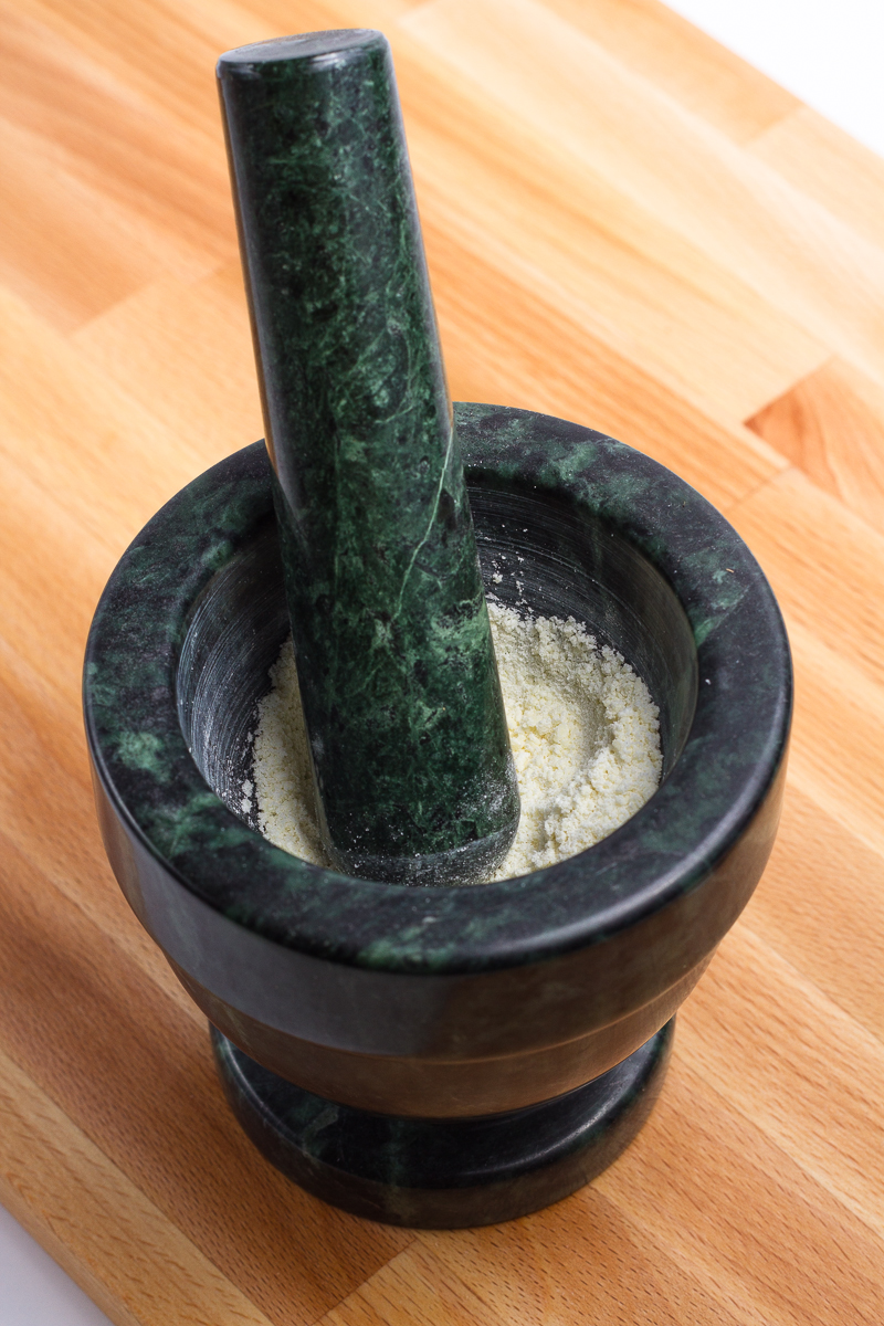 Dehydrated milk powder in a mortar and pestle